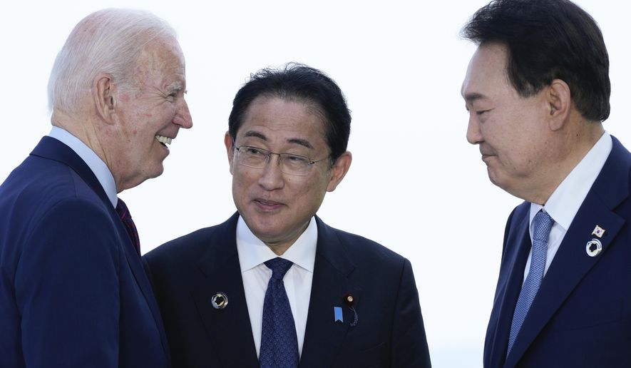 President Joe Biden, left, talks with Japan&#x27;s Prime Minister Fumio Kishida and South Korean President Yoon Suk Yeol, right, ahead of a trilateral meeting on the sidelines of the G7 Summit in Hiroshima, Japan, Sunday, May 21, 2023. Biden aims to further tighten security and economic ties between Japan and South Korea, two nations that have struggled to stay on speaking terms, as he welcomes their leaders to the rustic Camp David presidential retreat Friday, Aug. 18. (AP Photo/Susan Walsh) **FILE**