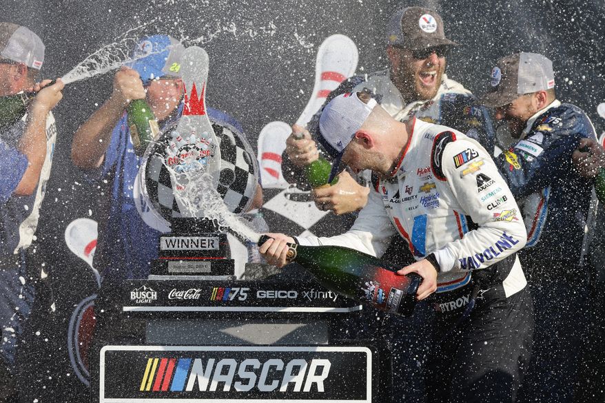 William Byron celebrates with his pit crew following a NASCAR Cup Series auto race in Watkins Glen, N.Y., Sunday, Aug. 20, 2023. (AP Photo/Jeffrey T. Barnes)
