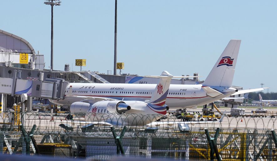 Ground crew work near an Air Koryo commercial plane on the tarmac at the Beijing Capital International Airport in Beijing, Tuesday, Aug. 22, 2023. A North Korean commercial flight has landed in Beijing amid signs that Pyongyang is opening borders again after almost three years of COVID-19 restrictions. (AP Photo/Andy Wong)