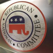 The Republican National Committee logo is shown on the stage as crew members work at the North Charleston Coliseum, on Jan. 13, 2016, in North Charleston, S.C. (AP Photo/Rainier Ehrhardt, File)