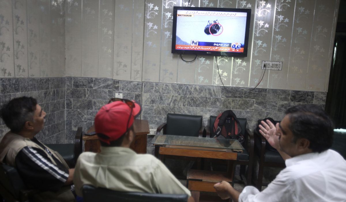 NextImg:Pakistani rescuers try to free 6 children and 2 men from a cable car hundreds of feet in the air
