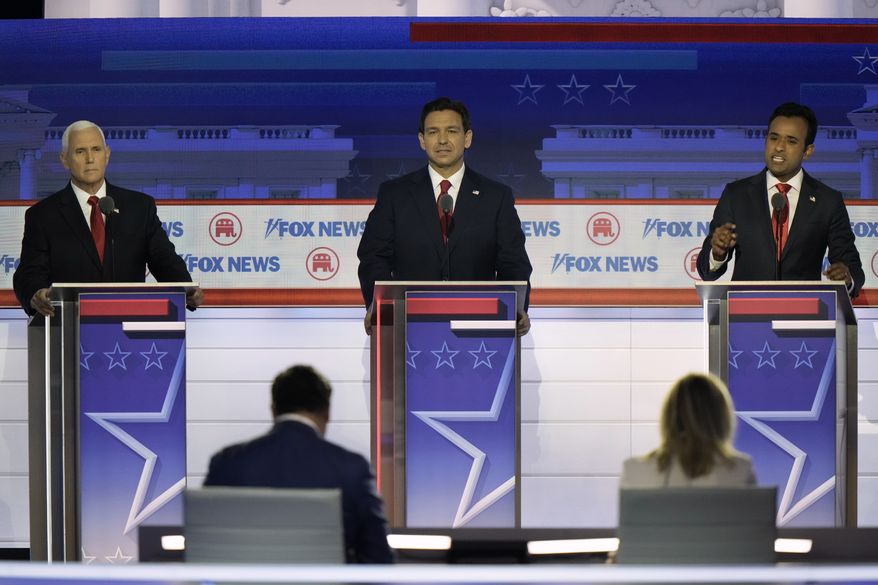 Businessman Vivek Ramaswamy speaks as former Vice President Mike Pence and Florida Gov. Ron DeSantis listen during a Republican presidential primary debate hosted by FOX News Channel Wednesday, Aug. 23, 2023, in Milwaukee. (AP Photo/Morry Gash)