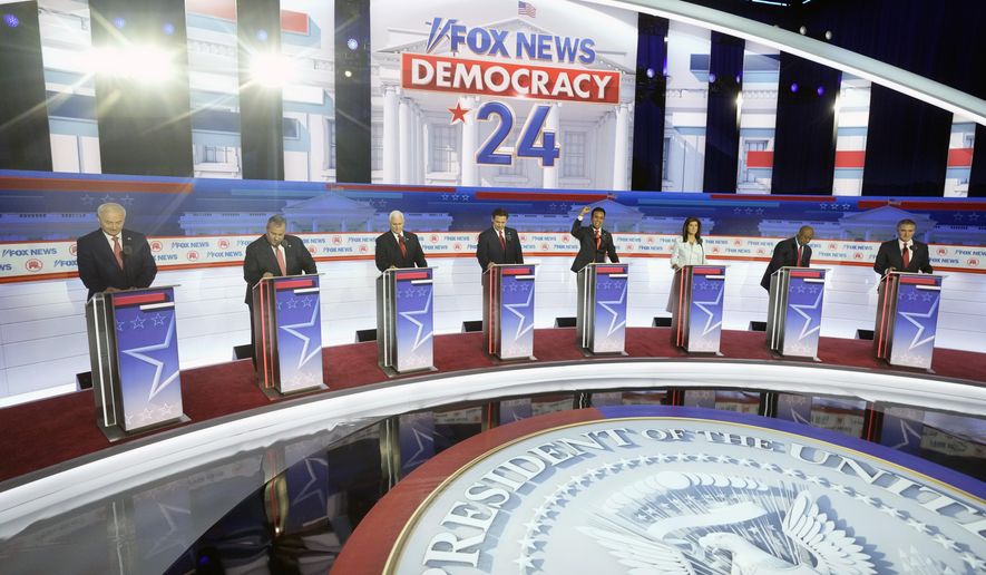 Republican presidential candidates, from left, former Arkansas Gov. Asa Hutchinson, former New Jersey Gov. Chris Christie, former Vice President Mike Pence, Florida Gov. Ron DeSantis, businessman Vivek Ramaswamy, former U.N. Ambassador Nikki Haley, Sen. Tim Scott, R-S.C., and North Dakota Gov. Doug Burgum stand on stage before a Republican presidential primary debate hosted by FOX News Channel Wednesday, Aug. 23, 2023, in Milwaukee. (AP Photo/Morry Gash, File)