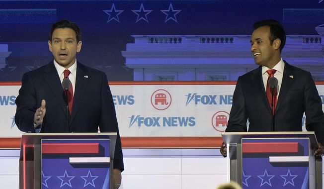 Florida Gov. Ron DeSantis speaks as businessman Vivek Ramaswamy listens during a Republican presidential primary debate hosted by FOX News Channel, Wednesday, Aug. 23, 2023, in Milwaukee. (AP Photo/Morry Gash, File)
