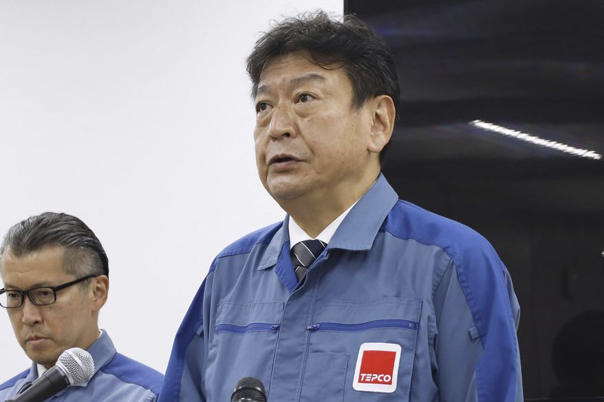 Tokyo Electric Power Company Holdings (TEPCO) President Tomoaki Kobayakawa speaks to reporters at the Fukushima Daiichi nuclear power plant in Fukushima, northern Japan, Thursday, Aug. 24, 2023. The tsunami-wrecked Fukushima Daiichi nuclear power plant began releasing its first batch of treated radioactive water into the Pacific Ocean on Thursday — a controversial step that prompted China to ban seafood from Japan. (Kyodo News via AP)