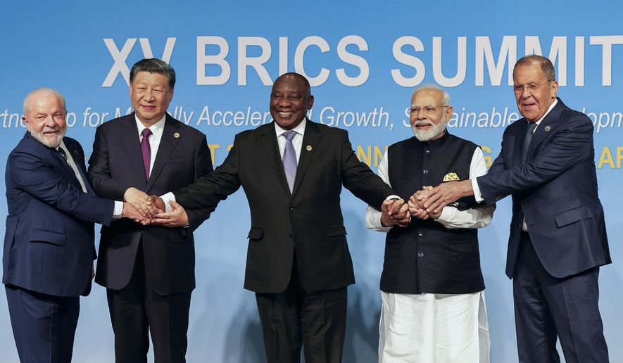 From left, Brazil&#x27;s President Luiz Inacio Lula da Silva, China&#x27;s President Xi Jinping, South Africa&#x27;s President Cyril Ramaphosa, India&#x27;s Prime Minister Narendra Modi and Russia&#x27;s Foreign Minister Sergei Lavrov pose for a BRICS group photo during the 2023 BRICS Summit at the Sandton Convention Centre in Johannesburg, South Africa, Wednesday, Aug. 23, 2023. (Gianluigi Guercia/Pool via AP)