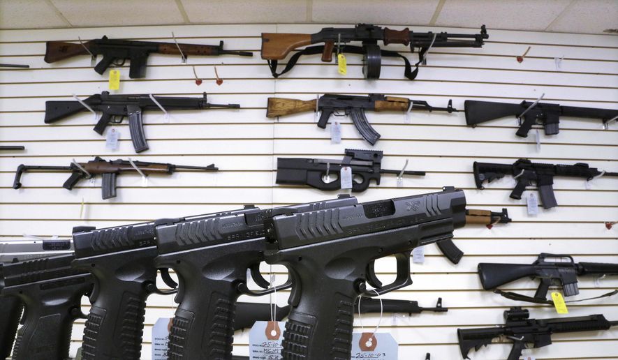 Assault weapons and handguns are seen for sale at Capitol City Arms Supply on Jan. 16, 2013, in Springfield, Ill. Republican support for gun restrictions is slipping a year after Congress passed the most comprehensive firearms control legislation in decades with bipartisan support, according to a poll from The Associated Press-NORC Center for Public Affairs Research. (AP Photo/Seth Perlman, File)