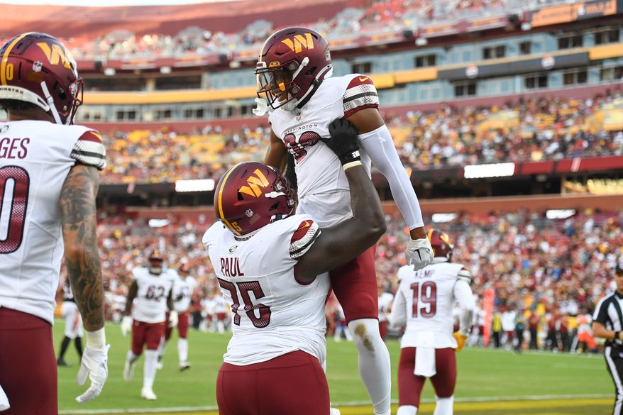 Washington Commanders wide receiver Mitchell Tinsley (86) being held up in the air by offensive guard Chris Paul (75) after his touchdown pass catch during the 1st Half of a preseason NFL game against the Cincinnati Bengals at FedEx Field in Landover, MD, August 26, 2023. (Photo by Billy Sabatini)