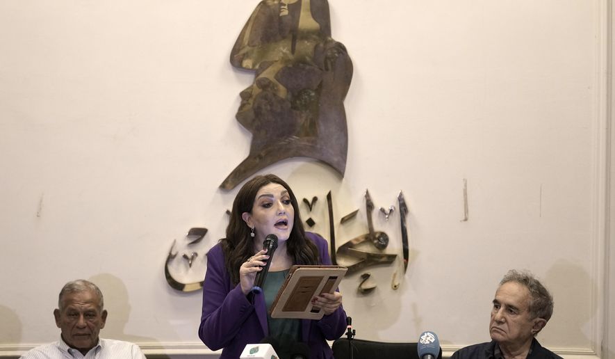 Gameela Ismail, center, the head of Egypt's al-Dostour Party, speaks during a presser held by the Free Current coalition in Cairo, Egypt, Monday, Aug. 28, 2023. A new coalition of Egyptian political parties has publicly criticized the country's current government on Monday for persecuting politicians. In a presser Monday a spokesmen for the coalition said the practices of the current government are a danger to the country's future. (AP Photo/Amr Nabil)