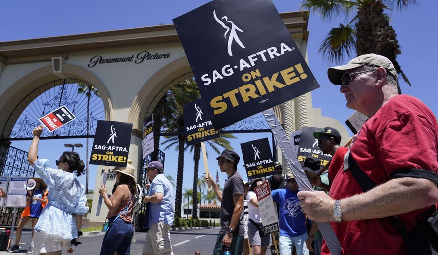 Striking writers and actors picket outside Paramount studios in Los Angeles on Friday, July 14, 2023. As worker actions continue from Hollywood to Detroit, and new labor unions crop up at firms like Starbucks and Amazon, the White House on Monday was highlighting its effort to bolster worker organizing throughout the U.S. (AP Photo/Chris Pizzello, File)
