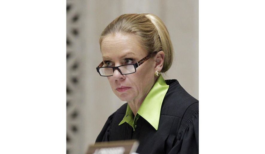 Wisconsin Supreme Court Justice Annette Ziegler listens to arguments at the Supreme Court, Nov. 11, 2013, in Madison, Wis. On Monday, Aug. 28, 2023, Ziegler, the conservative chief justice of the Wisconsin Supreme Court, told the new liberal majority in a scathing email that they had staged a “coup” and conducted an “illegal experiment” when they voted to weaken her powers and fire the director of state courts. (M.P. King/Wisconsin State Journal via AP, Pool, File)