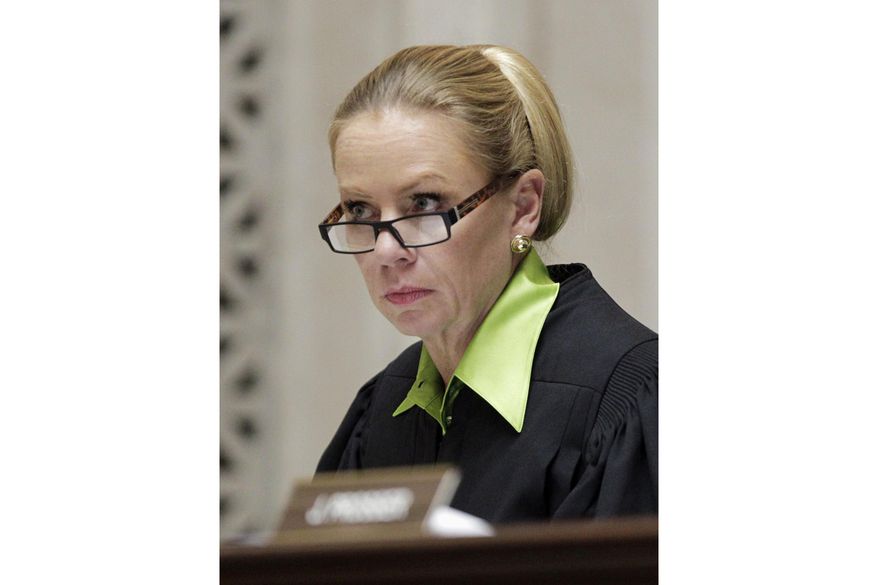 Wisconsin Supreme Court Justice Annette Ziegler listens to arguments at the Supreme Court, Nov. 11, 2013, in Madison, Wis. On Monday, Aug. 28, 2023, Ziegler, the conservative chief justice of the Wisconsin Supreme Court, told the new liberal majority in a scathing email that they had staged a “coup” and conducted an “illegal experiment” when they voted to weaken her powers and fire the director of state courts. (M.P. King/Wisconsin State Journal via AP, Pool, File)