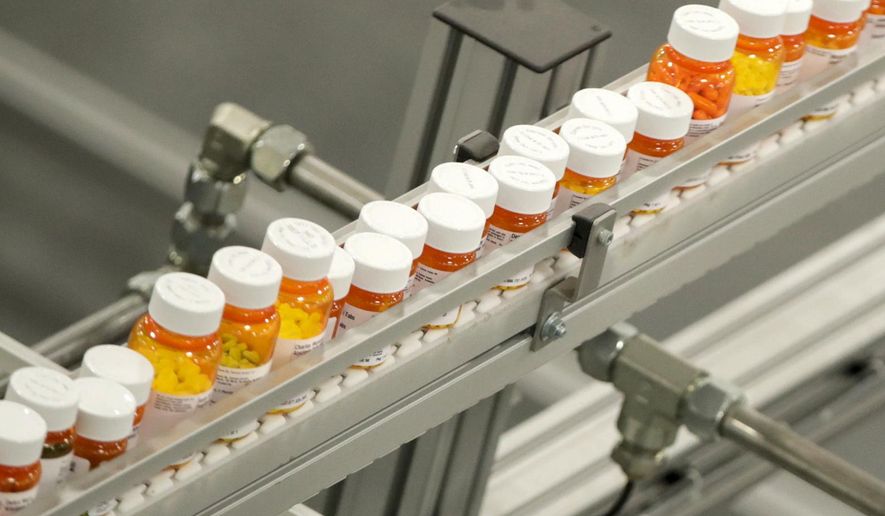 Bottles of medicine ride on a belt at a mail-in pharmacy warehouse in Florence, N.J., July 10, 2018. President Joe Biden&#x27;s administration will announce on Tuesday, Aug. 29, 2023, the first prescription drugs being targeted by the U.S. government for price negotiations as part of an effort to lower Medicare costs. (AP Photo/Julio Cortez, File)