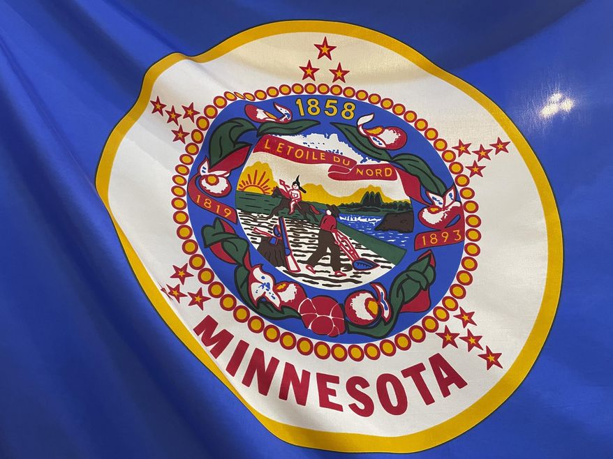 The Minnesota state flag is displayed in the state Capitol building rotunda, March 24, 2022, in St. Paul, Minn. A state commission went to work Tuesday, Sept. 5, 2023, on designing a new state flag and seal for Minnesota to replace a current emblem in both that's considered offensive to Native Americans. (Mohamed Ibrahim/Report for America via AP, File)