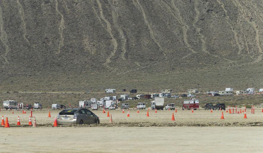 Vehicles line up to leave the Burning Man festival in Black Rock Desert, Nev., Tuesday, Sept. 5, 2023. (Monique Sady via AP) ** FILE **