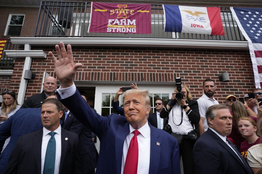 Former President Donald Trump waves as he visits the Alpha Gamma Rho, agricultural fraternity, at Iowa State University before an NCAA college football game between Iowa State and Iowa, Saturday, Sept. 9, 2023, in Ames, Iowa. (AP Photo/Charlie Neibergall)