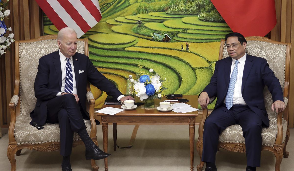 NextImg:Biden highlights business deals and pays respects at John McCain memorial to wrap up Vietnam visit