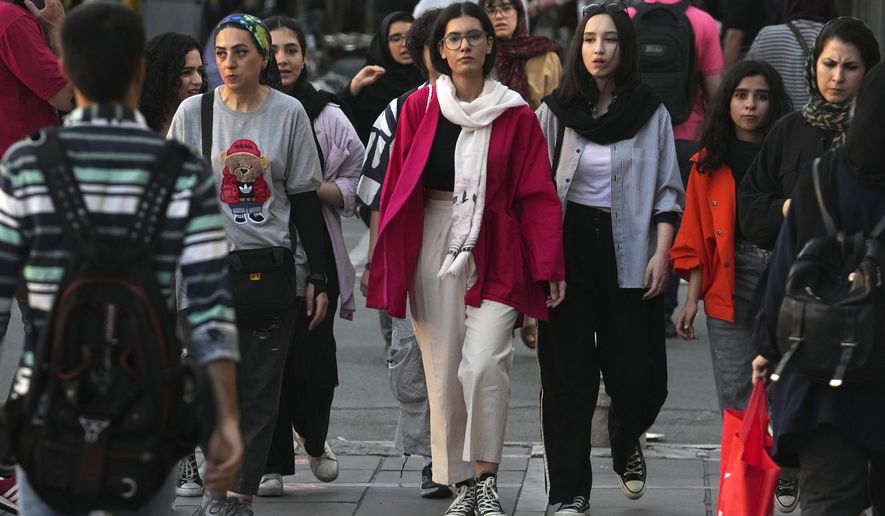 Iranian women, some without wearing their mandatory Islamic headscarves, walk in downtown Tehran, Iran, Saturday, Sept. 9, 2023. Iranians are marking the first anniversary of nationwide protests over the country&#x27;s mandatory headscarf law that erupted after the death of a young woman detained by morality police. (AP Photo/Vahid Salemi)