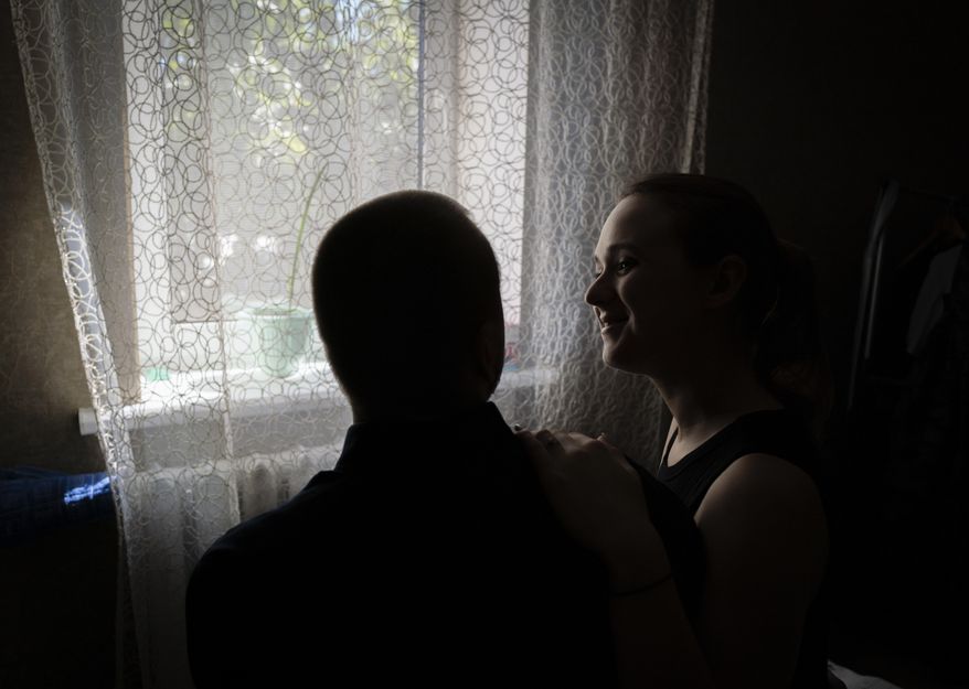 Vladislava Ryabets, right, turns towards his blind husband Ivan Soroka, left, during the second day of their wedding in the outskirt of Kyiv, Ukraine on Sunday, Sept. 10, 2023. Severe shrapnel wounds blinded Soroka permanently on Aug. 2, 2022 when Russian mortar fire struck his retreating unit near Bakhmut during the war's longest and bloodiest battle. Despite Soroka's injury the couple has been determined to move forward and get married. (AP Photo/Bela Szandelszky)
