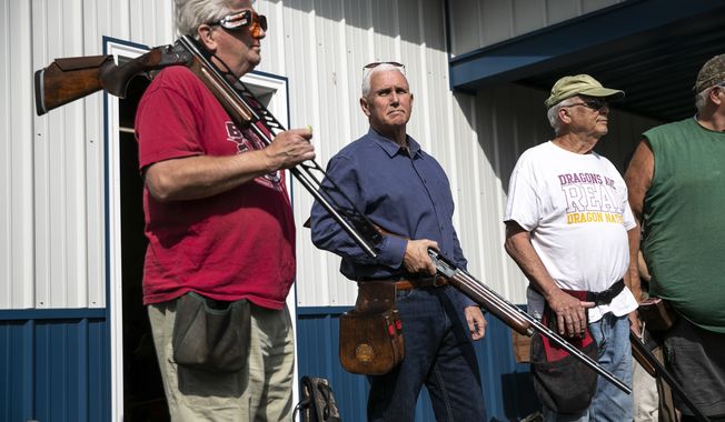 Former Vice President and current 2024 Republican presidential candidate Mike Pence receives safety instructions before his turn to shoot during the 10th annual Jasper County GOP trap shoot on Saturday, Sept. 16, 2023, at Jasper County Gun Club in Newton, Iowa. Four Republican presidential hopefuls, made a campaign stop at the event to speak with constituents and shoot a few rounds. (Geoff Stellfox/The Gazette via AP)