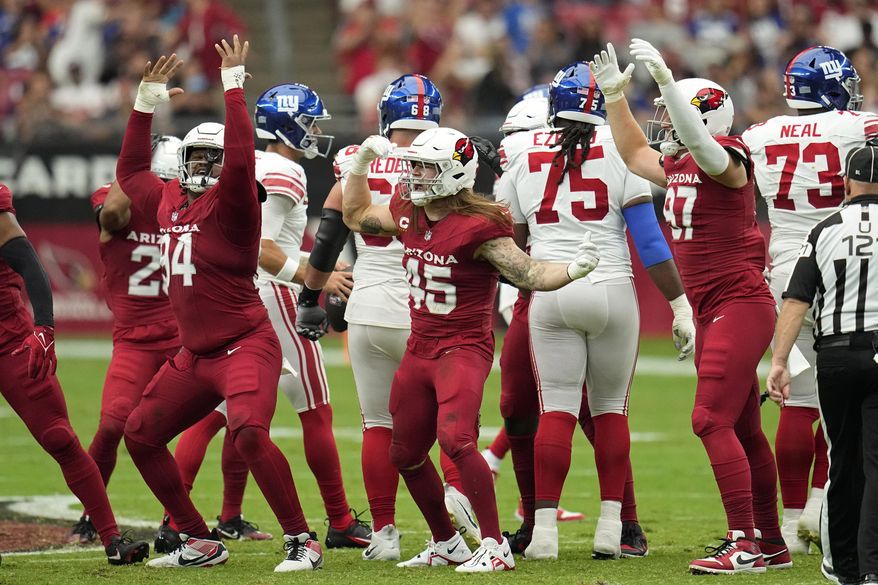Arizona Cardinals defensive tackle Carlos Watkins (94), linebacker Dennis Gardeck (45) and linebacker Cameron Thomas (97) react after a play against the New York Giants during the first half of an NFL football game, Sunday, Sept. 17, 2023, in Glendale, Ariz. (AP Photo/Ross D. Franklin)