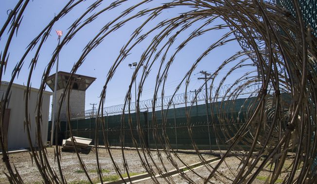 In this April 17, 2019, photo, reviewed by U.S. military officials, the control tower is seen through the razor wire inside the Camp VI detention facility in Guantanamo Bay Naval Base, Cuba. A military medical panel has concluded that one of the five 9/11 defendants held at Guantanamo Bay has been rendered delusional and psychotic by the torture he underwent years ago while in CIA custody. A military judge is expected to rule as soon as Thursday whether al-Shibh’s mental issues render him incompetent to take part in the proceedings against him. (AP Photo/Alex Brandon, File)