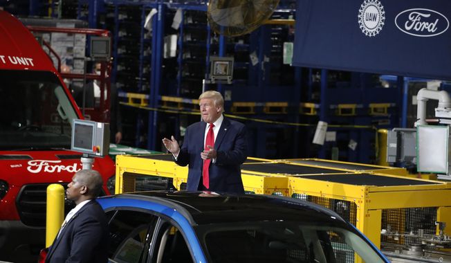 FILE - President Donald Trump claps as he walks to the podium to speak at Ford&#x27;s Rawsonville Components Plant that has been converted to making personal protection and medical equipment, Thursday, May 21, 2020, in Ypsilanti, Mich. Former President Donald Trump will skip the second GOP presidential debate next week to travel to Detroit as the auto worker strike enters its second week. Trump is planning to speak with union members and will look to blunt criticisms from a United Auto Workers union leadership that has said a second Trump term would be a “disaster.” (AP Photo/Alex Brandon, File)