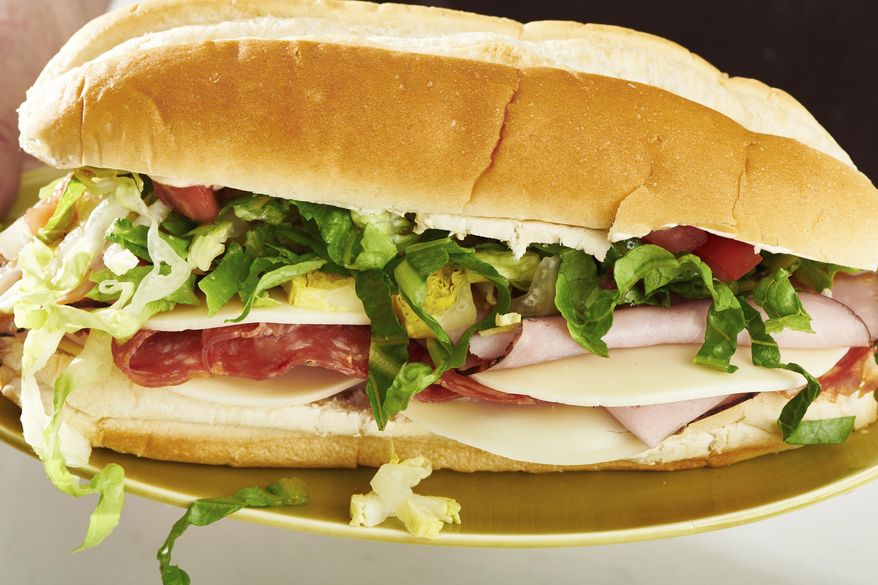 This May 2022 photo shows a submarine sandwich. The overstuffed sandwich on a roll has layers of meats, cheese, condiments and so on. (Cheyenne Cohen via AP)