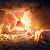Resurrection Of Jesus Christ - Tomb Empty With Shroud And Crucifixion At Sunrise With Abstract Magic Lights. File photo credit:  Romolo Tavani via Shutterstock.