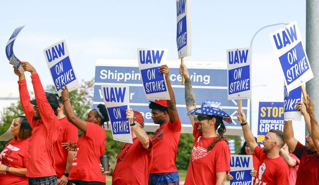 UAW members cheer as employees walkout from the Fort Worth Parts Distribution Center on Friday, Sept. 22, 2023, in Roanoke, Texas. (Shafkat Anowar/The Dallas Morning News via AP)
