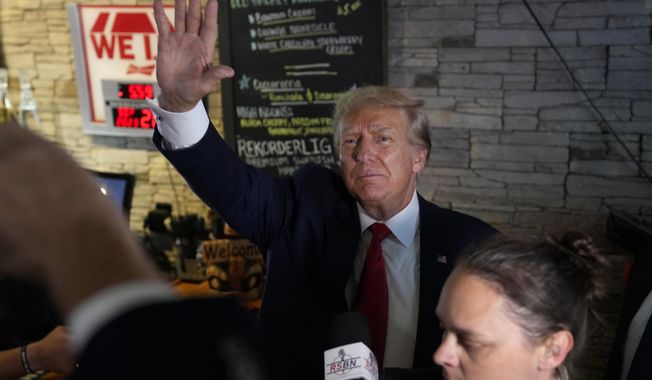Former President Donald Trump greets supporters at the Treehouse Pub &amp; Eatery, Wednesday, Sept. 20, 2023, in Bettendorf, Iowa. (AP Photo/Charlie Neibergall)