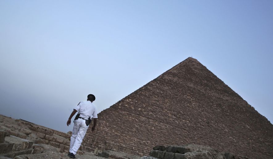An Egyptian policeman walks near a pyramid in Giza, Egypt, on Nov. 9, 2015. (AP Photo/Nariman El-Mofty) **FILE**