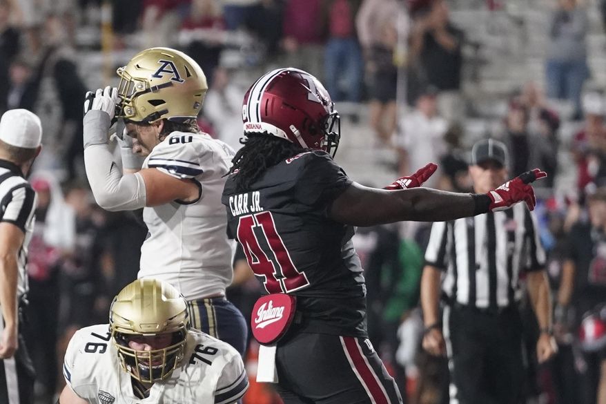 Indiana linebacker Lanell Carr Jr. (41) celebrates as he walks past Akron offensive lineman Nate Williams (76) and offensive lineman Ben Frank (60) after Indiana defeated Akron in four overtimes of an NCAA college football game, Saturday, Sept. 23, 2023, in Bloomington, Ind. (AP Photo/Darron Cummings)