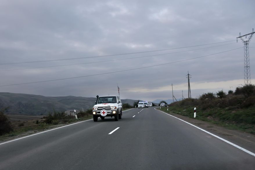 The motorcade with the first group of about 30 people drive from Nagorno-Karabakh to Armenia's Kornidzor village in Syunik region, Armenia, Sunday, Sept. 24, 2023. The first refugees from Nagorno-Karabakh have arrived in Armenia, local officials reported Sunday, and more were expected to come after a 10-month blockade and a lightning military offensive this month that resulted in Azerbaijan reclaiming full control of the breakaway region. (AP Photo/Vasily Krestyaninov)