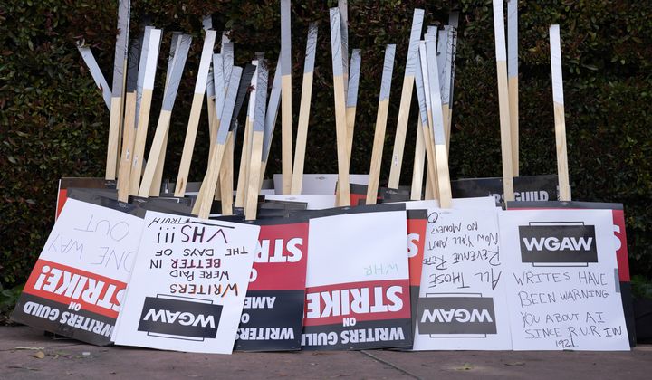Placards are gathered together at the close of a picket by members of The Writers Guild of America outside Walt Disney Studios, Tuesday, May 2, 2023, in Burbank, Calif. Unionized Canadian entertainment writers voted to authorize a strike this week, following in the footsteps of their peers in the U.S. (AP Photo/Chris Pizzello, File)
