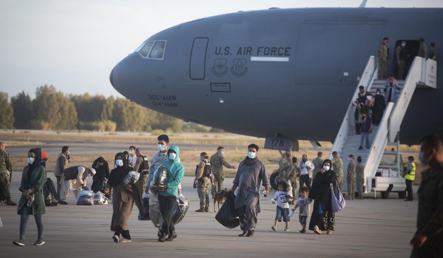 Evacuees from Afghanistan disembark from a U.S. airforce plane at the Naval Station in Rota, southern Spain, Tuesday Aug 31, 2021 after the United States completed its withdrawal from Afghanistan late Monday, ending America's longest war. The Afghan man who speaks only Farsi represented himself in U.S. immigration court, and the judge denied him asylum. The Associated Press obtained a transcript of the hearing that offers a rare look inside an opaque and overwhelmed immigration court system where hearings are closed and judges are under pressure to move quickly given the backlog of 2 million cases. (AP Photo/ Marcos Moreno, File)