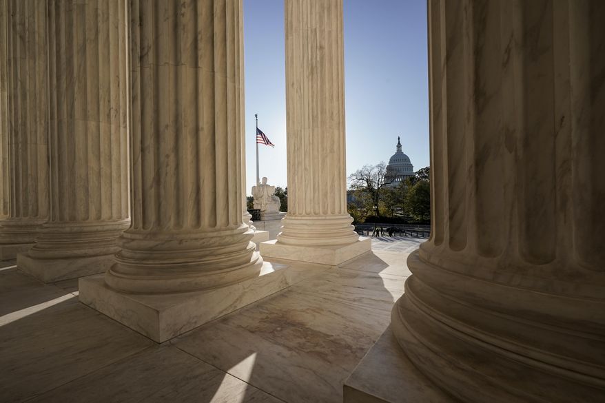 The Supreme Court is seen in Washington, with the U.S. Capitol in the distance, Nov. 4, 2020. It's hard to imagine a less contentious or more innocent word than “and.” But how to interpret the simple conjunction has prompted a complicated legal fight that lands in the Supreme Court on the first day of its new term next week. What the justices decide could affect thousands of prison sentences each year. (AP Photo/J. Scott Applewhite, File)