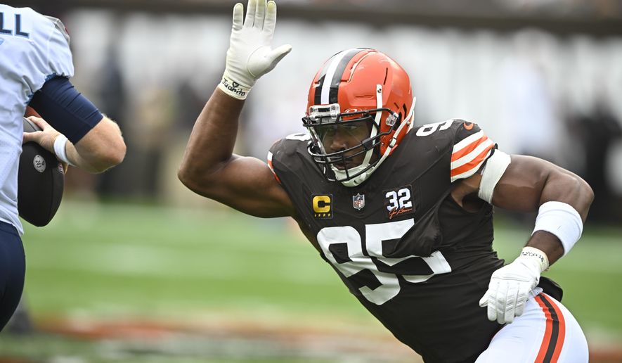Cleveland Browns defensive end Myles Garrett (95) pressures Tennessee Titans quarterback Ryan Tannehill, left, during the first half of an NFL football game Sunday, Sept. 24, 2023, in Cleveland. (AP Photo/David Richard)
