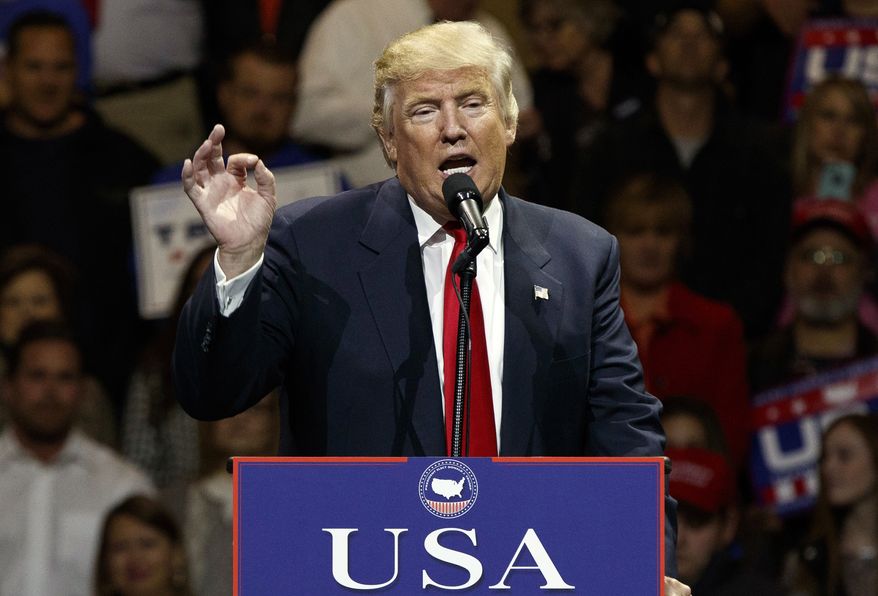 In this Dec. 1, 2016, photo, then President-elect Donald Trump gestures as he speaks during a "USA Thank You" tour event in Cincinnati. (AP Photo/Evan Vucci)