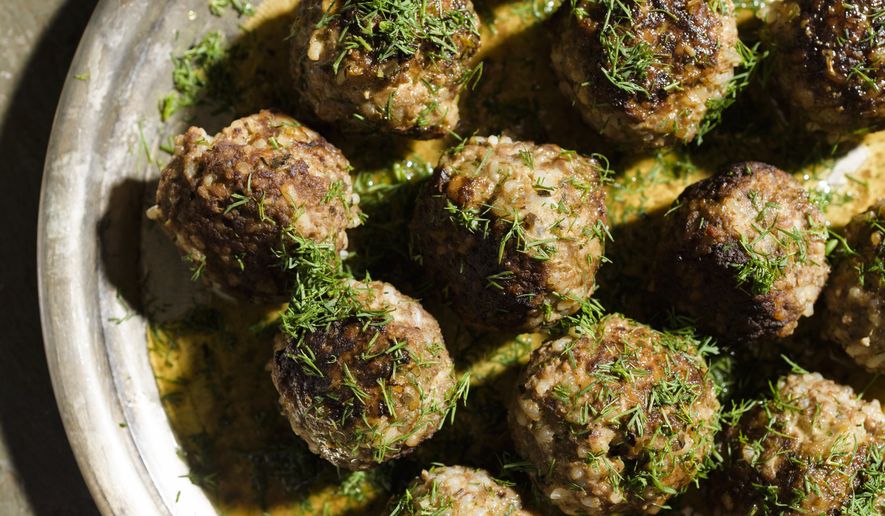 This image released by Milk Street shows a recipe for beef and rice meatballs with lemon-olive oil sauce. (Milk Street via AP)