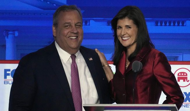 Former New Jersey Gov. Chris Christie, left, smiles next to former U.N. Ambassador Nikki Haley during a break in a Republican presidential primary debate hosted by FOX Business Network and Univision, Wednesday, Sept. 27, 2023, at the Ronald Reagan Presidential Library in Simi Valley, Calif. (AP Photo/Mark J. Terrill)