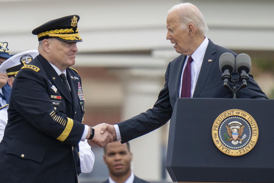 President Joe Biden, right, shakes hands with outgoing Joint Chiefs Chairman Gen. Mark Milley, during an Armed Forces Farewell Tribute in honor of Milley at Joint Base Myer–Henderson Hall, Friday, Sept. 29, 2023, in Fort Meyer, Va. Also held was an Armed Forces Hail in honor of Gen. CQ Brown, Jr., who the Senate confirmed as the next chairman of the Joint Chiefs of Staff. (AP Photo/Alex Brandon)