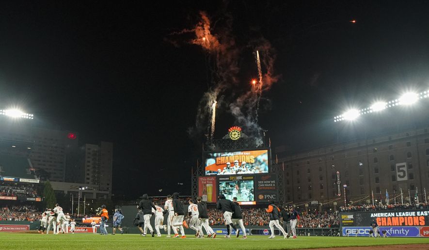 Baltimore Orioles players celebrate after defeating the Boston Red Sox 2-0 in a baseball game to win the AL East championship Thursday, Sept. 28, 2023, in Baltimore. (AP Photo/Julio Cortez)