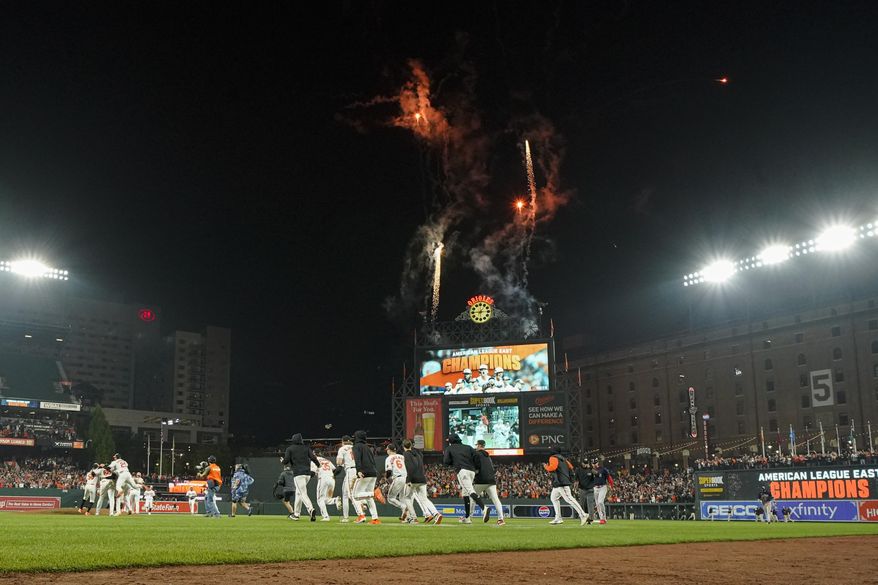 Baltimore Orioles players celebrate after defeating the Boston Red Sox 2-0 in a baseball game to win the AL East championship Thursday, Sept. 28, 2023, in Baltimore. (AP Photo/Julio Cortez)