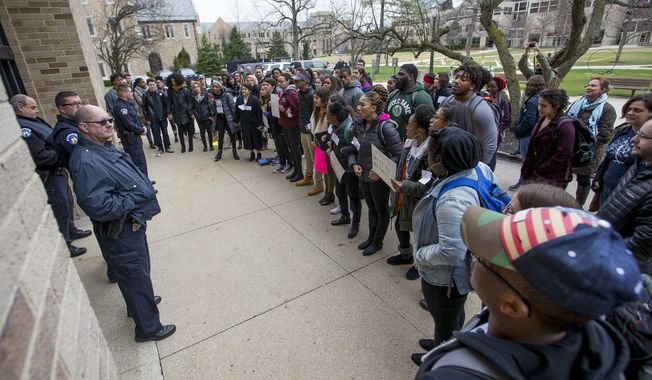 Police block the entrance into McKenna Hall as Notre Dame students protest an event featuring Charles Murray, a controversial conservative speaker, writer and academic, March 28, 2017, on the campus of the University of Notre Dame in South Bend, Ind. New polling finds that America鈥檚 college campuses are seen as far friendlier to liberals than to conservatives when it comes free speech. Polling from the University of Chicago and the AP-NORC Center for Public Affairs Research finds that 47% of adult Americans say liberals are free to express their views on college campuses, while 20% said the same of conservatives. (Robert Franklin/South Bend Tribune via AP)