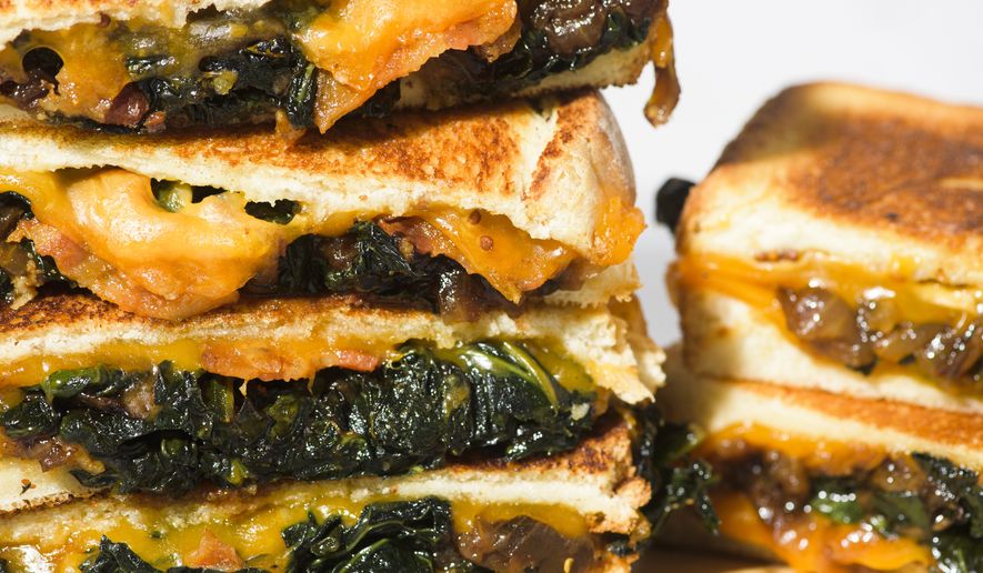 This image released by Milk Street shows a recipe for kale and cheddar melts. (Milk Street via AP)