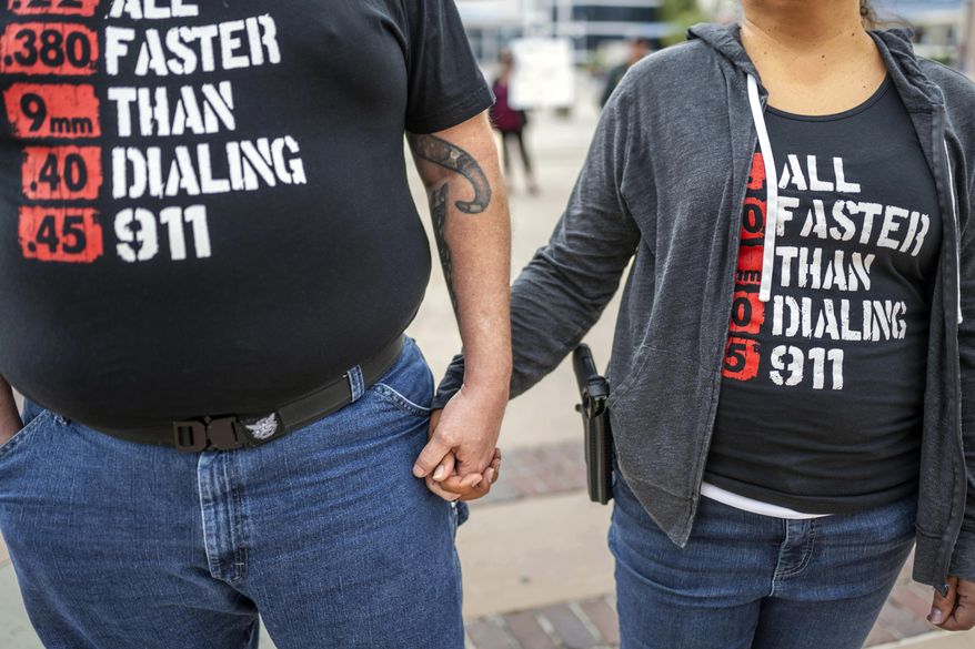 Albuquerque residents Michael Caldwell, left, and his wife, Natasha Caldwell, attend a Second Amendment Protest in response to Gov. Michelle Lujan Grisham's recent public health order suspending the conceal and open carry of guns in and around Albuquerque for 30 days, Tuesday, Sept. 12, 2023, in Albuquerque, N.M. Natasha said, "We came to stand for the Constitution and out of anger about what's happening with this health order." Restrictions on carrying guns in public that are tied to an emergency public health order are going under the legal microscope on Tuesday, Oct. 3, in New Mexico. (AP Photo/Roberto E. Rosales) **FILE**