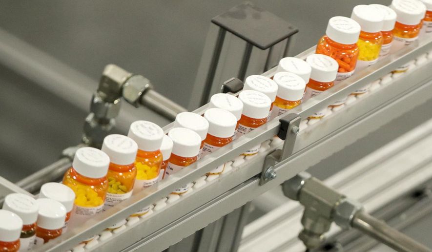Bottles of medicine ride on a belt at a mail-in pharmacy warehouse in Florence, N.J., July 10, 2018. The Biden administration says the manufacturers of all of the first 10 prescription drugs it selected for Medicare’s first price negotiations have agreed to participate. Tuesday&#x27;s announcement clears the way for talks that could lower their costs in coming years and gives the White House a potential political win heading into next year’s presidential election. (AP Photo/Julio Cortez, File)