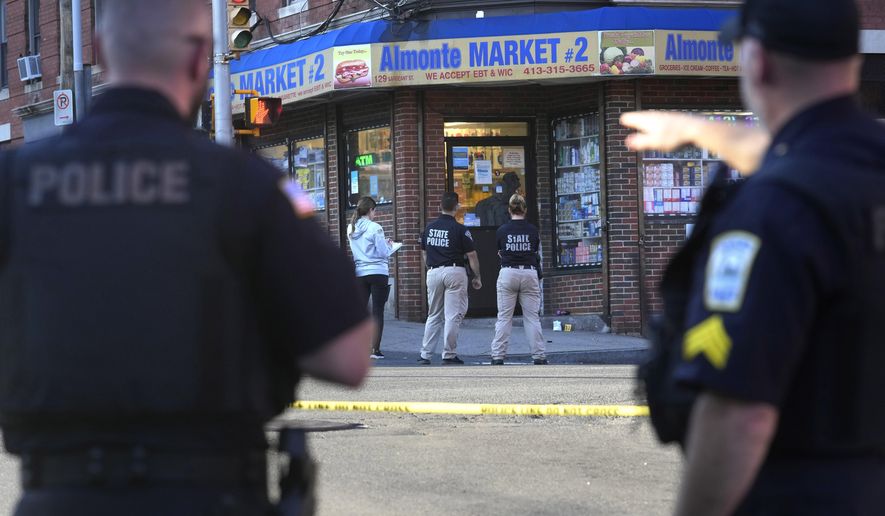 Law enforcement officials investigate the scene where multiple were shot, Wednesday, Oct. 4, 2023, in Holyoke, Mass. State police say at least three people, including a person riding a bus, were shot Wednesday in Holyoke following a fight on a downtown street. (AP Photo/Steven Senne)