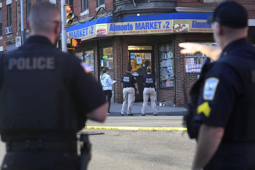 Law enforcement officials investigate the scene where multiple were shot, Wednesday, Oct. 4, 2023, in Holyoke, Mass. State police say at least three people, including a person riding a bus, were shot Wednesday in Holyoke following a fight on a downtown street. (AP Photo/Steven Senne)